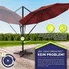 An outdoor patio scene with a red umbrella and instructional graphics. Produktbild-Vorschau