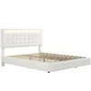 A white upholstered bed frame with a tufted headboard and LED lighting, shown from a side angle on a white background. Produktbild-Vorschau