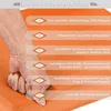 A hand pressing into an orange balance pad, with text describing product features. Podgląd zdjęcia produktu