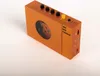 An orange portable cassette player with a circular window showing the cassette mechanism, placed on a white background. Náhled obrázku produktu