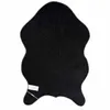 The back of a black rug with a patterned texture. Produktbild-Vorschau