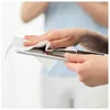 A person is cleaning a tablet with a wet wipe. Náhľad obrázku produktu