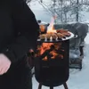 A person is cooking sausages and other food items on a grill in a snowy outdoor environment. Produktbild-Vorschau