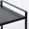 A close-up view of a black metal shelf with a handle. Voir les images du produit