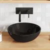 A black ceramic sink with a black faucet mounted on a white tiled wall, set on a wooden countertop. Podgląd zdjęcia produktu