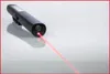 A black flashlight with a red laser beam emitting from the front, placed on a reflective surface. Podgląd zdjęcia produktu