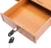 A close-up view of an open wooden drawer with a lock and two keys. Podgląd zdjęcia produktu