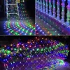 A net of colorful LED lights draped over plants and a railing. Produktbild-Vorschau