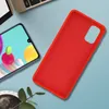 A red phone case is placed next to a smartphone on a light blue surface. A laptop keyboard is visible in the background. Produktbild-Vorschau