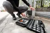 A person is working on a gate motor with a tool kit nearby. Anteprima dell’immagine prodotto