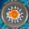 A robotic pool cleaner is shown from a top-down view, floating on the surface of a swimming pool. Produktbild-Vorschau