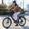 A man is riding an electric bicycle outdoors on a paved path. Produktbild-Vorschau