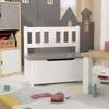 A children's toy storage bench with a white bench and gray top, set in a play area with other toy storage units and a rug. Produktbild-Vorschau