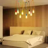 A bedroom with a bed and a colorful spider pendant light fixture hanging from the ceiling. Anteprima dell’immagine prodotto