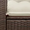 A close-up view of a brown poly rattan sofa with cream cushions. Podgląd zdjęcia produktu