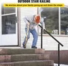An elderly man uses a stair railing to ascend steps outside a house. Anteprima dell’immagine prodotto