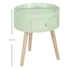 A light green round side table with a drawer and three wooden legs, shown against a white background with dimensions indicated. Voir les images du produit