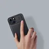 A hand is shown holding a black iPhone case with a camera lens protector. Produktbild-Vorschau