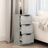 A gray three-drawer cabinet is placed next to a bed with a white throw blanket. Anteprima dell’immagine prodotto