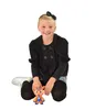 A young girl is kneeling on the floor with a toy in front of her. Voir les images du produit