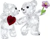 Two crystal teddy bears, one holding a red heart and the other holding a purple flower. Produktbild-Vorschau