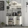 A white coffee bar cabinet with various coffee accessories displayed on shelves. Produktbild-Vorschau