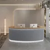 A modern reception desk with two computer monitors in a clean, minimalist interior. Produktbild-Vorschau