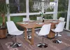 A dining set with a wooden table and white chairs in a sunroom setting. Anteprima dell’immagine prodotto
