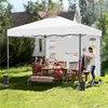 People enjoying a picnic under a white canopy in a backyard. Produktbild-Vorschau