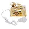 A golden 4-cylinder Stirling engine model with a USB cable and an LED light bulb. Produktbild-Vorschau