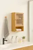 A bamboo bathroom cabinet mounted on a white wall above a white countertop with a sink and faucet. Produktbild-Vorschau
