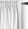 A close-up view of white curtains hanging from a curtain rod. Produktbild-Vorschau