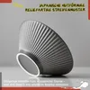 A dark gray ceramic bowl with a ribbed pattern, displayed on a light gray surface. Produktbild-Vorschau