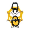 A pair of yellow and black crampons with silver chains, isolated on a white background. Produktbild-Vorschau