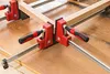 Four clamps are used to hold together wooden pieces to form a frame. Náhľad obrázku produktu