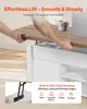 A person is lifting the top of a coffee table, demonstrating its effortless lift feature. The image also includes text overlays highlighting product features. Voir les images du produit