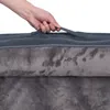 A hand is shown holding a handle on a dark gray dog bed. Produktbild-Vorschau