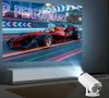 A projector is projecting an image of a red race car on a screen, with the projector itself visible in the foreground. Produktbild-Vorschau