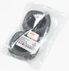 Two black ear pads are shown inside a clear plastic bag, with a label attached. Anteprima dell’immagine prodotto