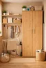A laundry room or utility space with a cabinet, shelves, and cleaning supplies. Anteprima dell’immagine prodotto