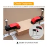 Two red and black clamps are shown holding a wooden block on a silver track system. A smaller inset image shows two similar clamps. Produktbild-Vorschau