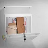 A white mailbox mounted on a textured wall, with its door open to reveal mail inside. Produktbild-Vorschau