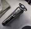 A close-up shot of a Philips electric shaver on a textured surface, with a folded cloth and a glass in the background. Náhled obrázku produktu