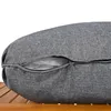 A close-up view of a gray cushion with a zipper partially open, revealing the white filling inside. The cushion is resting on a wooden surface. Podgląd zdjęcia produktu