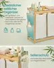 A split image showing a bamboo laundry basket with two compartments and a side organizer with bottles and towels. The bottom half shows a closer view of the laundry basket with items on top and in the side pockets. Produktbild-Vorschau