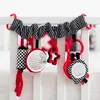 A baby crib toy hanging from the side of a crib. Podgląd zdjęcia produktu
