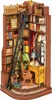 A miniature diorama of a cozy study nook with bookshelves, a desk, and a rocking chair. Náhled obrázku produktu