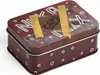 A close-up, slightly angled view of a small, rectangular tin box with a dark red base color and white polka dots around the sides. The top of the tin has white lettering that appears to spell out "NUKA MIX" with a brown patch in the center that has the wor Podgląd zdjęcia produktu