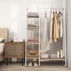 A bedroom scene with a clothing rack and shelving unit. Náhľad obrázku produktu