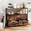 A storage cabinet with drawers and shelves is placed next to a sofa in a room. Anteprima dell’immagine prodotto